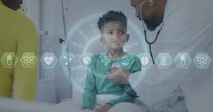 Animation of icons and data over african american male doctor with boy patient. Global medicine, healthcare, digital interface, computing and data processing concept digitally generated video.