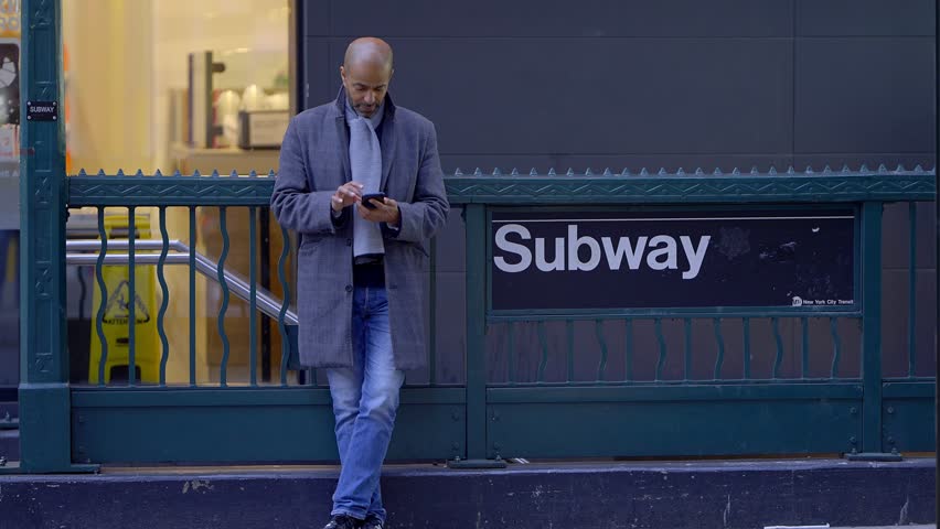 Man waiting at a subway entrance in New York - travel photography