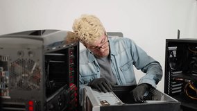 Young man tired and exhausted of repairing desktop computer. Technician, repair computer service concept