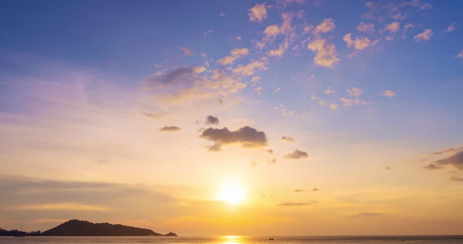 Time lapse of Majestic sunset or sunrise over sea landscape,Amazing light of nature cloudscape sky and Clouds moving away rolling, Colorful sunset light dramatic clouds in golden hour Footage | Shutterstock HD Video #1100969523