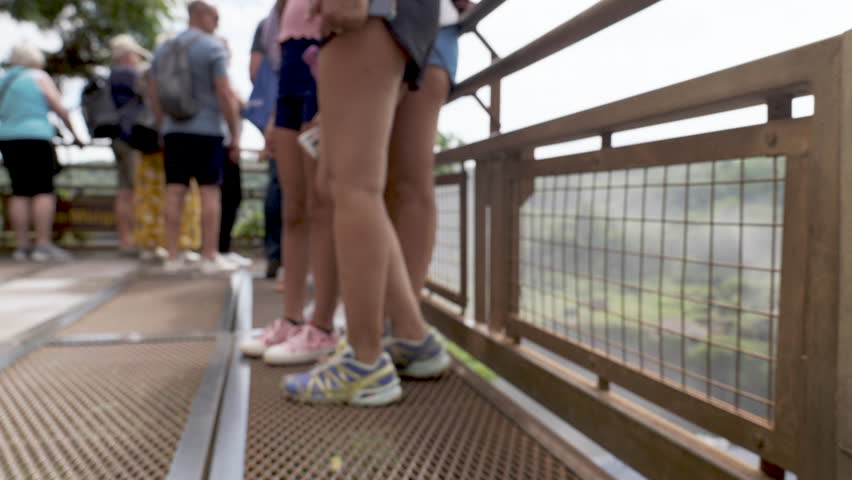 Unrecognized Tourists being enchanted by the Iguazu Falls on the Argentina Side