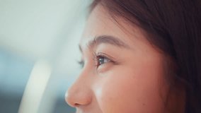 Close up - Attractive young asian woman opens his black eyes on a blurred background, Enjoy moment of peace, do mental relaxation exercises, feels no stress concept - Powered by Shutterstock - Get 15% off with code: PIKWIZARD15