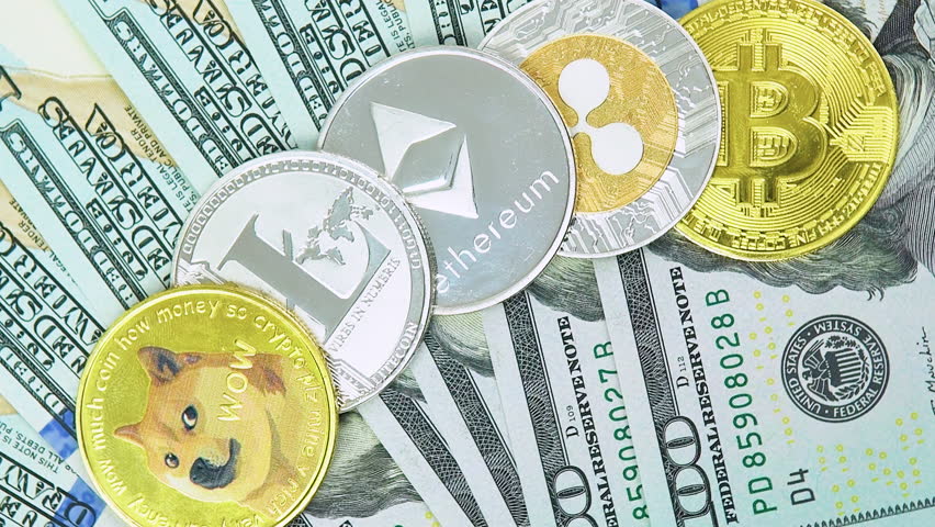 Bitcoin BTC, Ethereum ETH, Ripple XRP, Litecoin LTC, Dogecoin DOGE coins are rotating on bills of 100 dollars. Digital coin cyberspace and cryptocurrency. Concept of exchange market and online payment