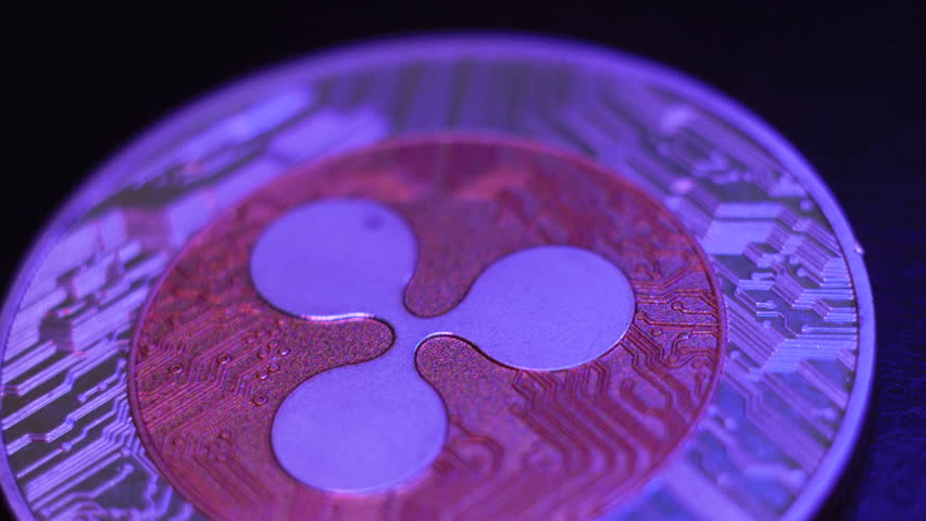 Macro shot of Ripple coin. Golden Ripple, crypto currency. Digital exchange, popularity of xrp, symbol of future money