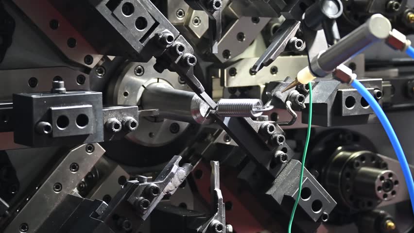 Close up scene the spring coiling machine operation. The mechanical parts manufacturing concept. - Powered by Shutterstock - Get 15% off with code: PIKWIZARD15