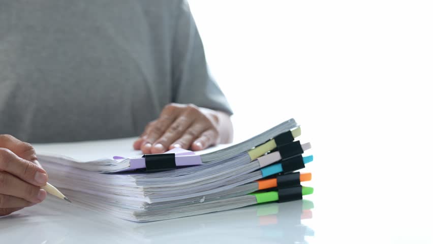 Hands of Asian male business woman working in stacks of paper files to search and verify financial documents. and the details of the unfinished trading contract agreement in the document folder.	
 Royalty-Free Stock Footage #1100988427