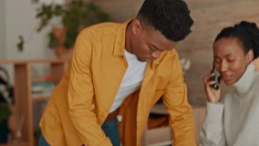 African couple with a suitcase for travel, vacation or holiday while wife is talking on phone call. Black people planning and packing clothes in their luggage for adventure or honeymoon trip together - Powered by Shutterstock - Get 15% off with code: PIKWIZARD15