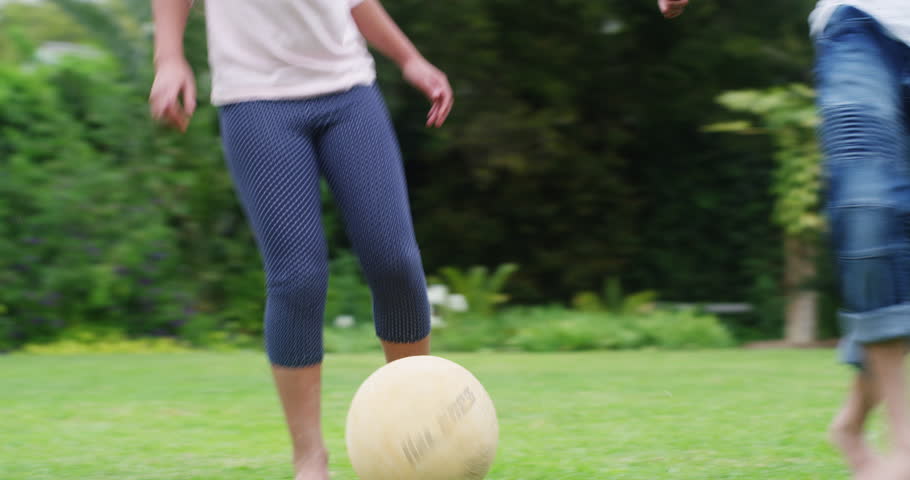 Family, fitness and kids playing football, exercise and fun at home with soccer ball in backyard. Siblings enjoying freedom and energy outdoors, bonding in childhood game and being active in garden | Shutterstock HD Video #1100990591