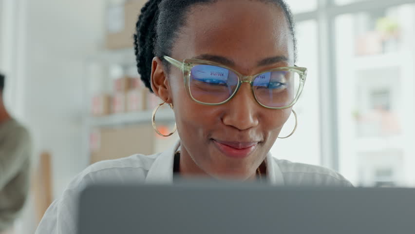 Wow, good news and omg face of a black woman on a computer reading at work with glasses. Female facial expression with shock and surprise from online announcement using pc technology while working Royalty-Free Stock Footage #1100991023
