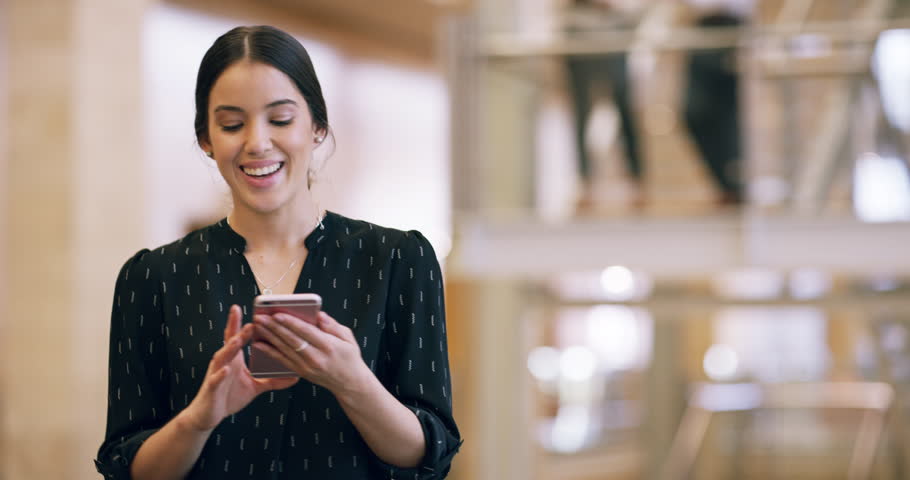 Making business connections. 4k video footage of an attractive young businesswoman sending a text message while at work. | Shutterstock HD Video #1100991477