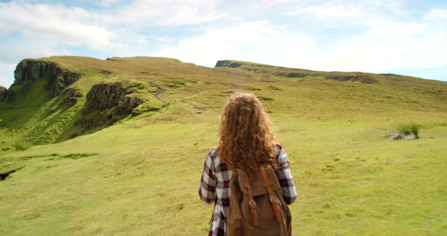 Woman, hiking and backpacking on mountain for nature freedom, countryside trekking adventure and sustainable travel. Female traveller in Ireland, walking outdoor alone and wellness vacation getaway Royalty-Free Stock Footage #1100991635