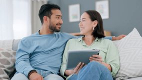 Asian couple, tablet and talking while doing online shopping, research or browsing social media to relax on couch at home. Enjoying internet entertainment with mobile app during weekend or free time - Powered by Shutterstock - Get 15% off with code: PIKWIZARD15