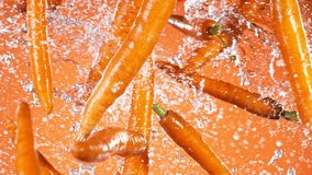 Super slow motion of fresh carrots with water splashes flying in the air. Filmed on high speed cinema camera, 1000 fps. - Powered by Shutterstock - Get 15% off with code: PIKWIZARD15