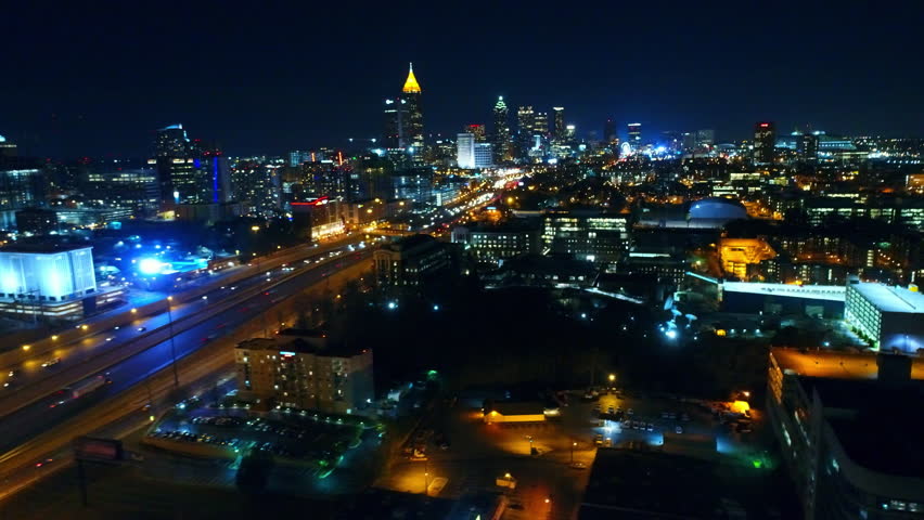 Aerial Shot Of Cars Moving On Illuminated Roads, Drone Panning Over Modern Buildings In City At Night - Atlanta, Georgia