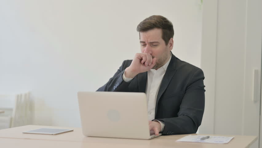 Businessman Coughing while Working on Laptop | Shutterstock HD Video #1100999191