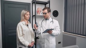 Consultation of the ENT doctor with the patient. Male doctor with an inhaler for asthmatics - Powered by Shutterstock - Get 15% off with code: PIKWIZARD15