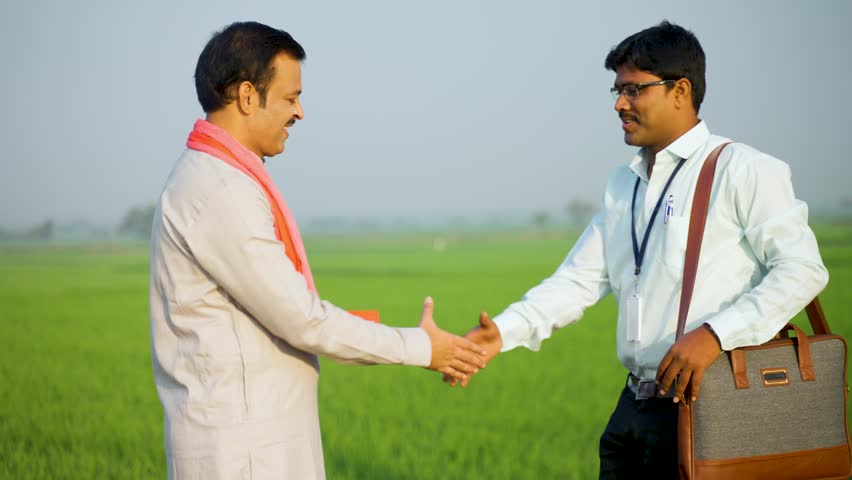 Happy village farmer greeting banker by hand shake by showing paddy field - concept of financial support, service and agriculture investment or banking. Royalty-Free Stock Footage #1101000509
