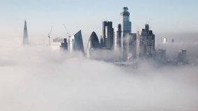 Aerial View Shot of London UK, United Kingdom, Square Mile, City of London and Shard, cloudy foggy fog