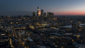 Aerial View Shot of London UK, United Kingdom, Square Mile, City of London,  slow push in, dusk dawn, stunning light, far