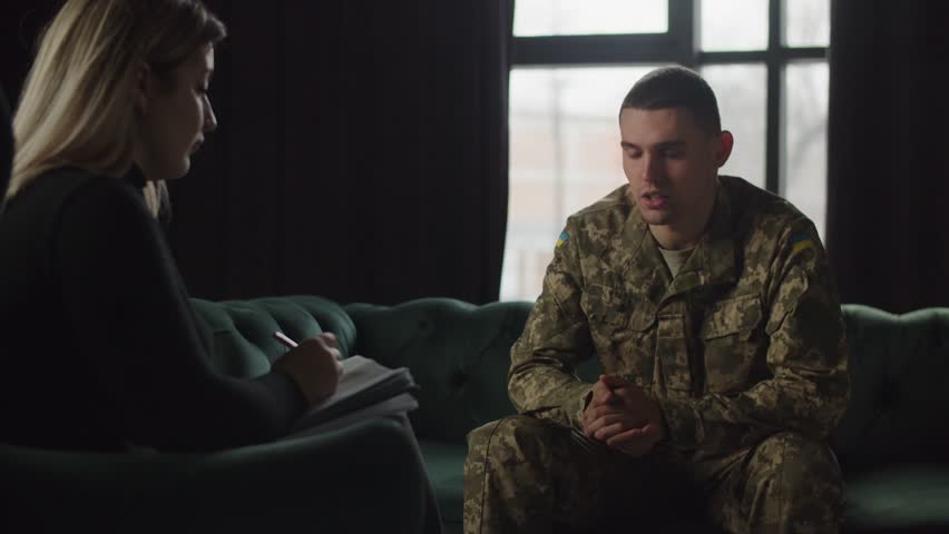 A young soldier of the Armed Forces of Ukraine at a psychotherapist's appointment. A young soldier turned to a psychotherapist with complaints of psychological trauma due to the horrors he saw in the | Shutterstock HD Video #1101002521