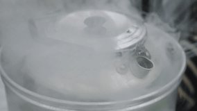 Close up of an outdoor cooking set where large amounts of steam is rising from the top pot that contains boiling water. Filmed outdoors with a handheld, stabilized video in Denmark during winter.