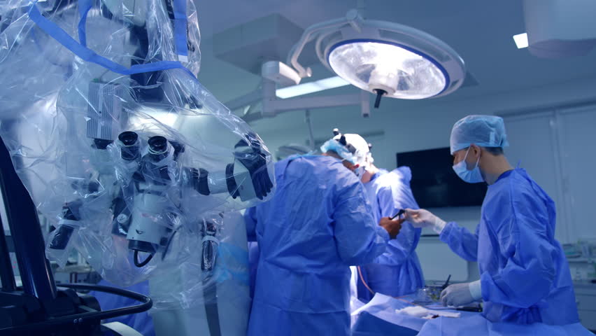Surgical room with technological equipment. Doctor’s team perform operation under the bright lamp. | Shutterstock HD Video #1101004625
