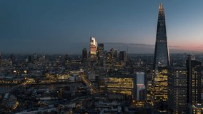 Establishing Aerial View Shot of London UK, United Kingdom, passing Shard and pushing into City of London, dusk, dawn, evening, stunning light