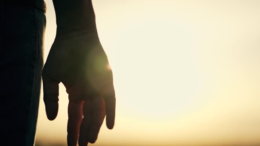 Silhouette of parent, small child holding hands at sunset. Happy family holding hands together. parent takes care of child. Hands at sunset silhouette. Take child by hand. Royalty-Free Stock Footage #1101006033