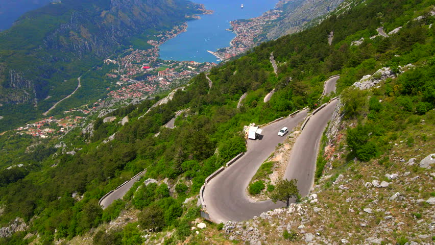 This breathtaking aerial footage captures the winding Kotor-Cetinje serpentine in Montenegro, showcasing its scenic beauty and dramatic twists and turns. With the stunning Boka-Kotor bay visible below Royalty-Free Stock Footage #1101010363
