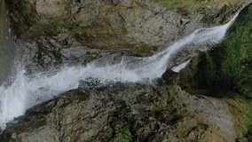 Vertical video, slow motion: Andrew the Apostle waterfall in the mountain - river or stream of water flowing and falling down in Batumi, Georgia. Nature, landscape and environment concept