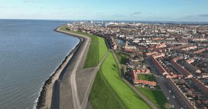 A bird's-eye view of Den Helder reveals the stunning juxtaposition of cityscape and coastline, creating a breathtaking visual experience.