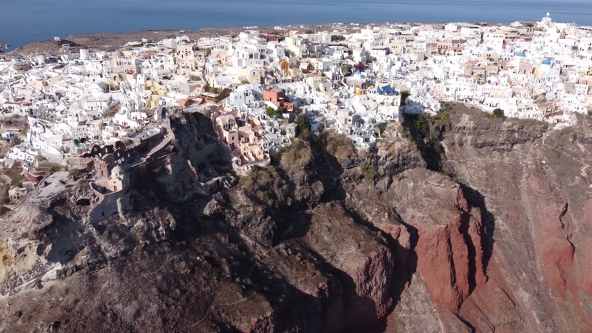Scenic View Over The Famous Village Of Oia At The Island Santorini, Greece - aerial drone shot