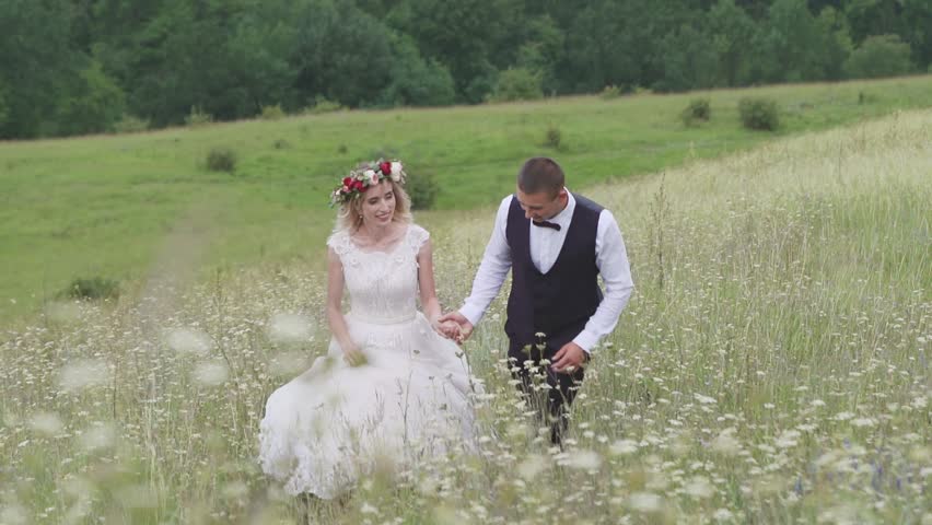 Affectionate Young Couple Slow Dance in a Field Together