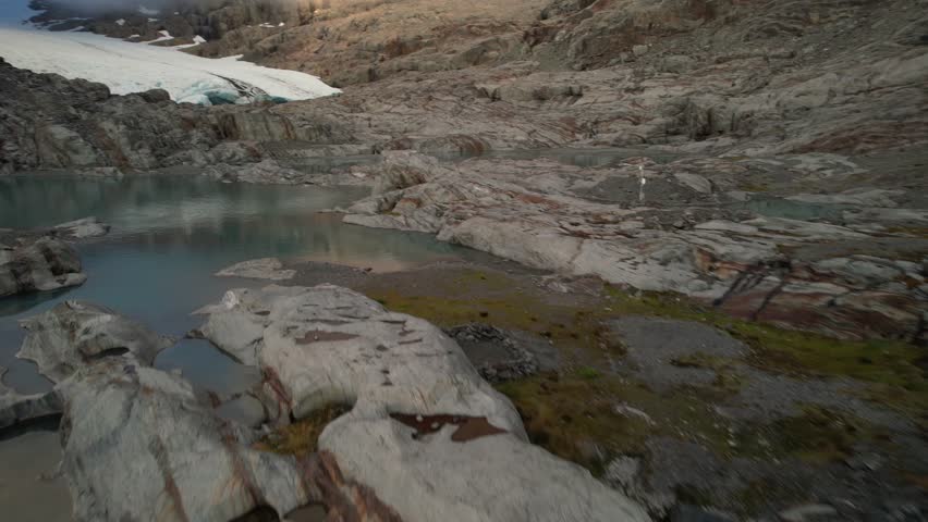 Aerial over lake to spectacular Brewster Glacier ice formations, Aspiring National Park, New Zealand