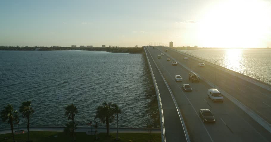 Aerial over highway bridge in Tampa Bay at sunset near St. Petersberg Florida