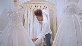 African American female designer designing bridal gown in wedding studio. Attractive young woman tailor dressmaker working and enjoy making new pattern collection of dress in fitting room at the store - Powered by Shutterstock - Get 15% off with code: PIKWIZARD15