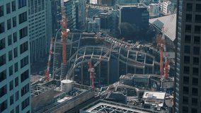 4K construction time lapse video with cranes working on a new building site from Tokyo. Construction industry in Japan view from above.
