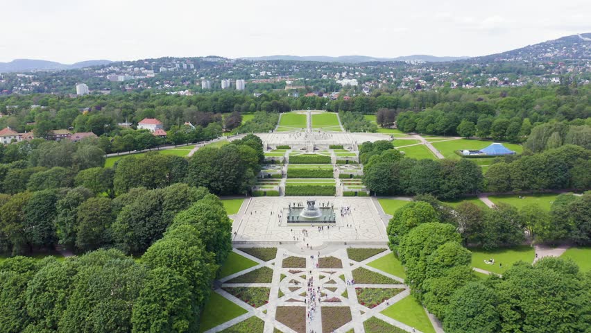 Inscription on video. Oslo, Norway. Public park in the city of Oslo. Aerial view. Different colors letters appears behind small squares, Aerial View, Departure of the camera