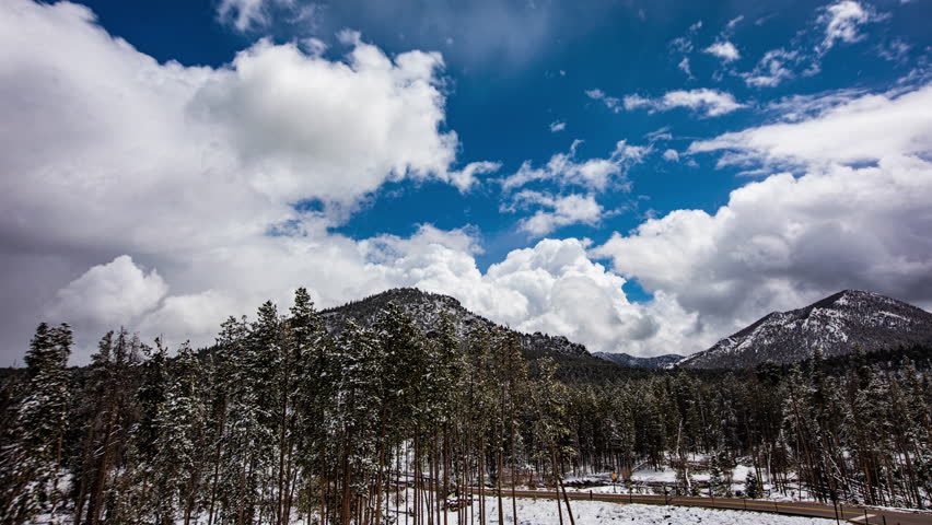 Beautiful cloudscape over the mountains and trees in Rocky Mountain National Park in Colorado, USA