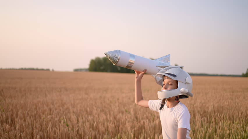 Cute little boy child teenager in helmet aviator cosmonaut running with toy rocket in sunset field summer nature. Kid big dream flying, astronaut, space. Concept of success leader winner travel Royalty-Free Stock Footage #1101025293