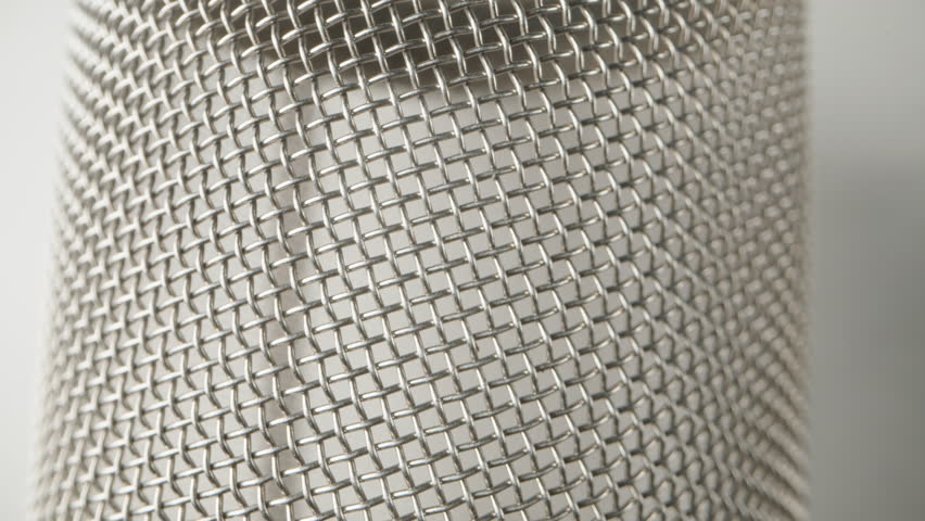 A glass for tea made of metal mesh. Dolly slider extreme close-up.
