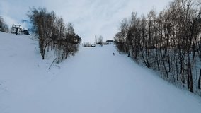 A skier rides at a ski resort, aerial photography of a skier, fpv shooting