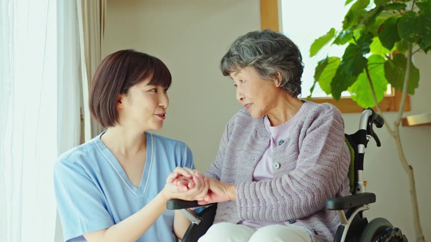 Senior woman in wheelchair with female health care worker | Shutterstock HD Video #1101026255