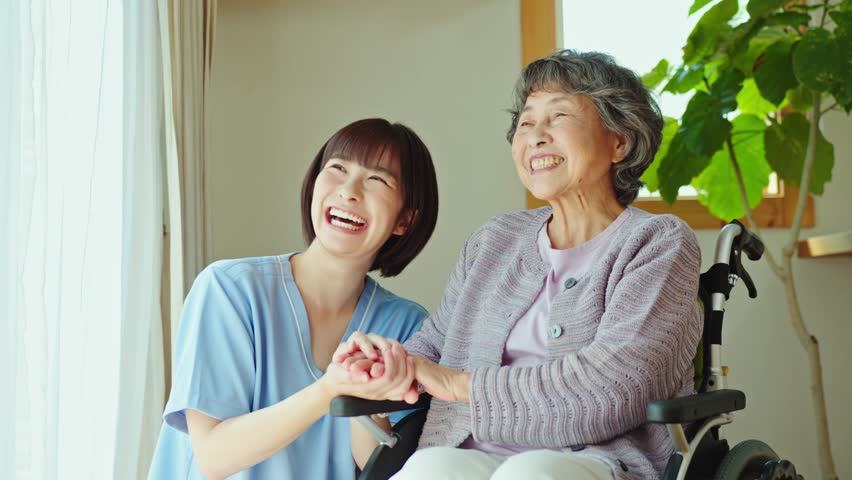 Senior woman in wheelchair with female health care worker | Shutterstock HD Video #1101026257