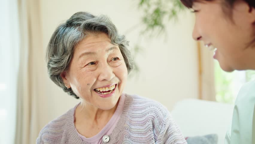 Senior woman talking with grandchildren in living room | Shutterstock HD Video #1101026329