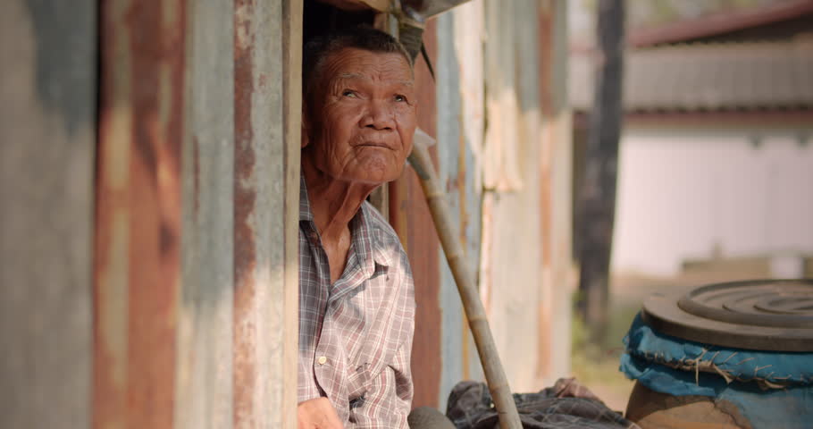 The Asian male farmer who is a poor elderly native looked up at the sky as though something had happened. Used in humanity, documentary, lonely person, environment, concepts, or movies.  Royalty-Free Stock Footage #1101027979