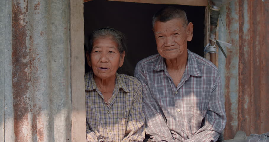 Happy smiling Asian woman and her husband who are poor elderly native farmer sitting on a narrow window. Used in humanity documentary concepts.  Royalty-Free Stock Footage #1101027989