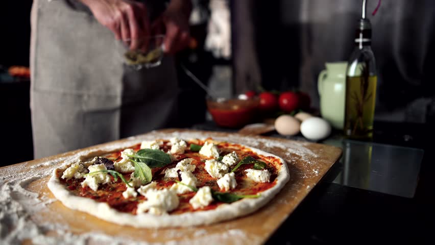 Pizzaiolo Chef Cooking Italian Pizza Making. Seasoning Oregano In Pizza. Pizzaiolo Making Pizza Margherita Seasoning Dry Basil And Oregano. Chef Cooking Tasty Margherita Pizza In Italian Restaurant Royalty-Free Stock Footage #1101029677