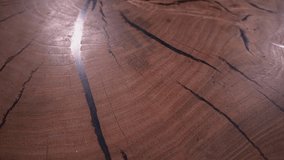 a wooden surface is slowly shown. glare of light from the surface. slow motion video. round table. High quality Full HD video recording