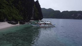 Aerial video of boats, turquoise water color Nido Palawan Philippines